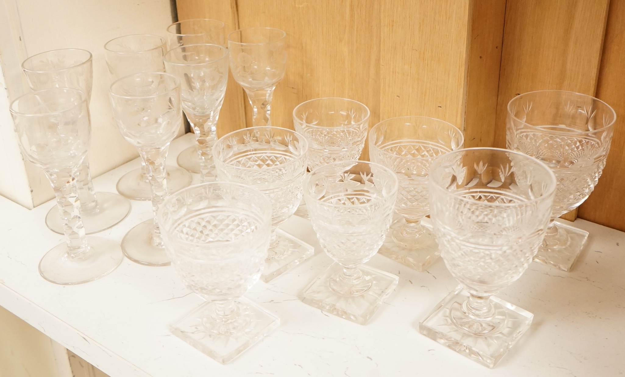 Seven Georgian style facet stem engraved wine glasses and a part suite of 19th centuy rummers, largest 14cm high
